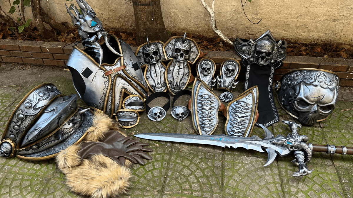 EVA foam costume pieces laid out on a garden floor, featuring armor plates, gauntlets, and intricate detailing.