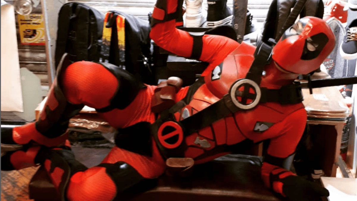 Cosplayer taking a break at a convention, wearing detailed EVA foam armor, staying comfortable and hydrated.