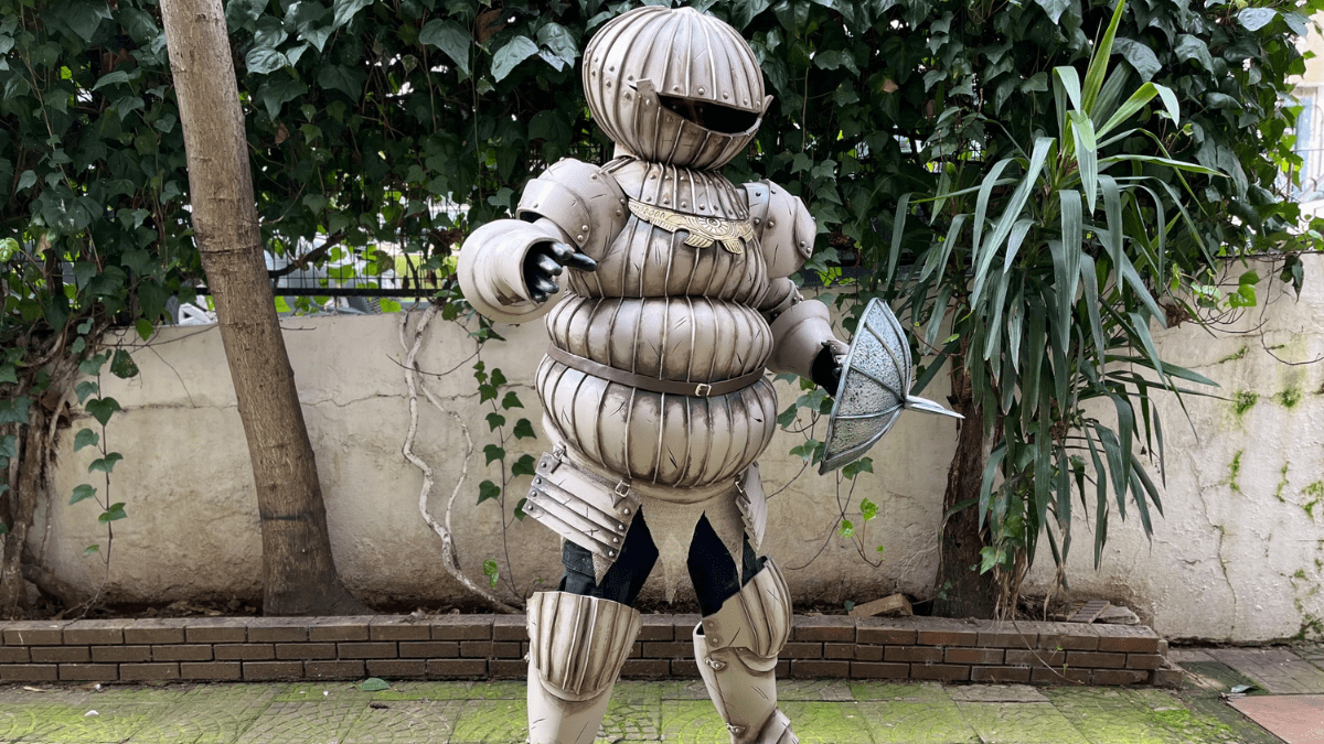 Cosplayer wearing a metallic-painted costume crafted from EVA foam armor, showcasing detailed textures and realistic metal finish.
