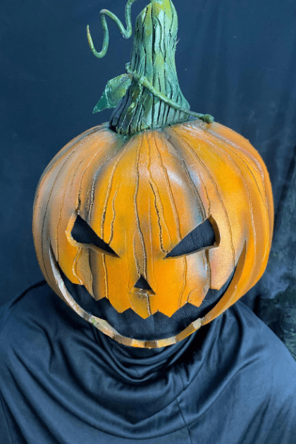 Front view of Spooky Pumpkin Headpiece worn on head showing detailed pumpkin design.